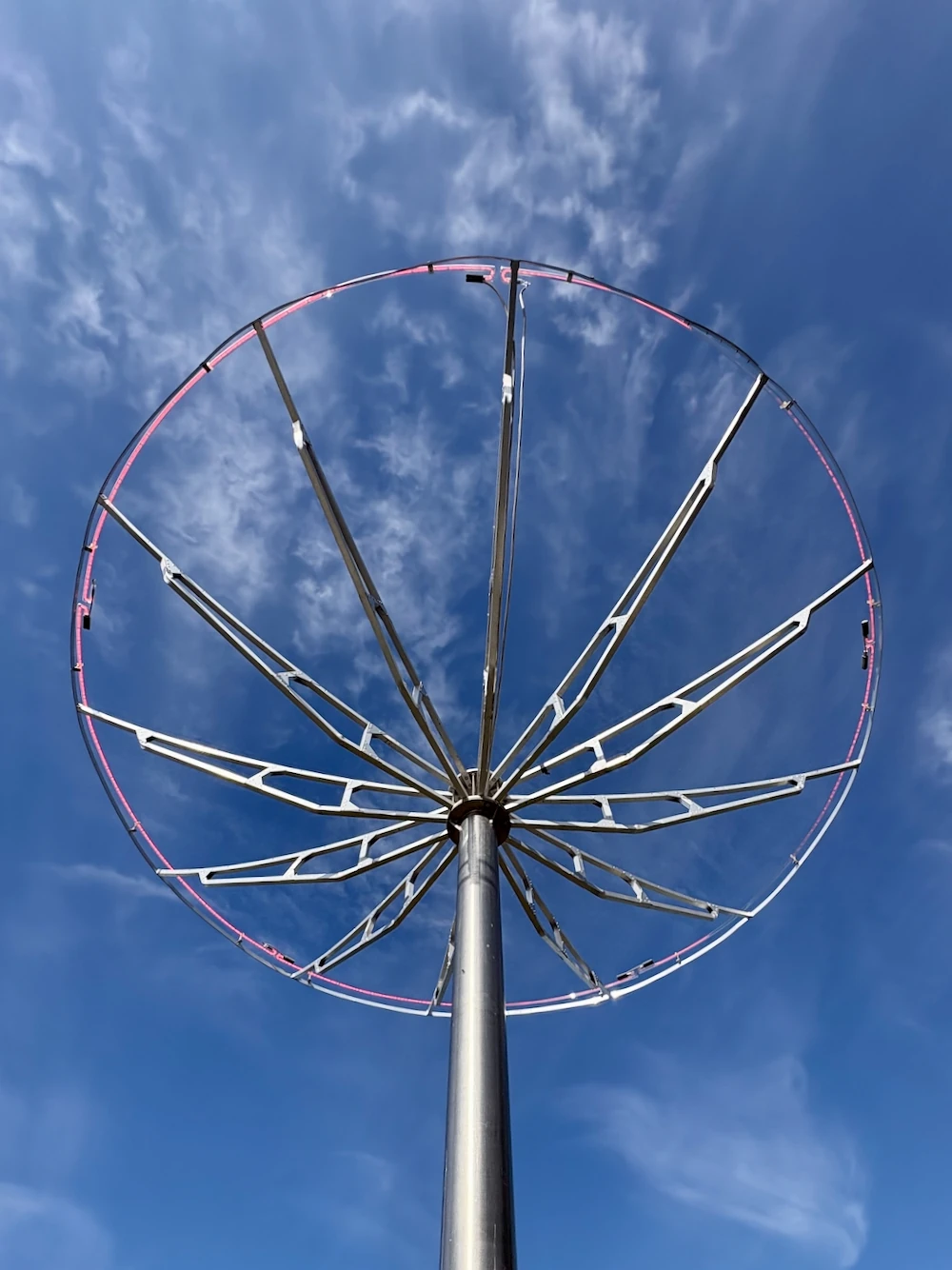 Radial metal frame with a pink neon ring
